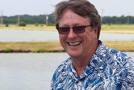 David Wise, research professor and coordinator of the Thad Cochran National Warmwater Aquaculture Center at the ponds where vaccines are delivered in late July. (Photo by David Ammon)