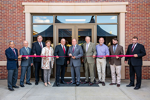 Administrators and partners involved in making the Animal and Dairy Sciences Building a reality were on hand to commemorate the opening of the building with a ribbon-cutting ceremony Monday [Sept. 30]. Pictured left to right: David Howell, Mississippi Agricultural and Forestry Experiment Station engineer; David Shaw, MSU provost and executive vice president; Gary Jackson, director of the MSU Extension Service; Amy Tuck, vice president of MSU Campus Services; George Hopper, dean of the College of Agriculture and Life Sciences and MAFES director; MSU President Mark E. Keenum; Reuben Moore, interim vice president of the Division of Agriculture, Forestry and Veterinary Medicine; Colin Maloney, president and CEO of Century Construction; Justin Harrington, architect at McCarty Architects; and John Blanton, animal and dairy sciences department head and interim associate director of MAFES.