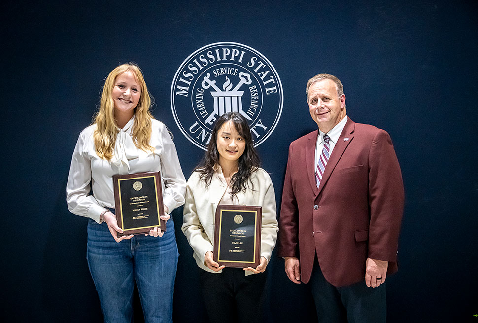 Student research winners with plaques