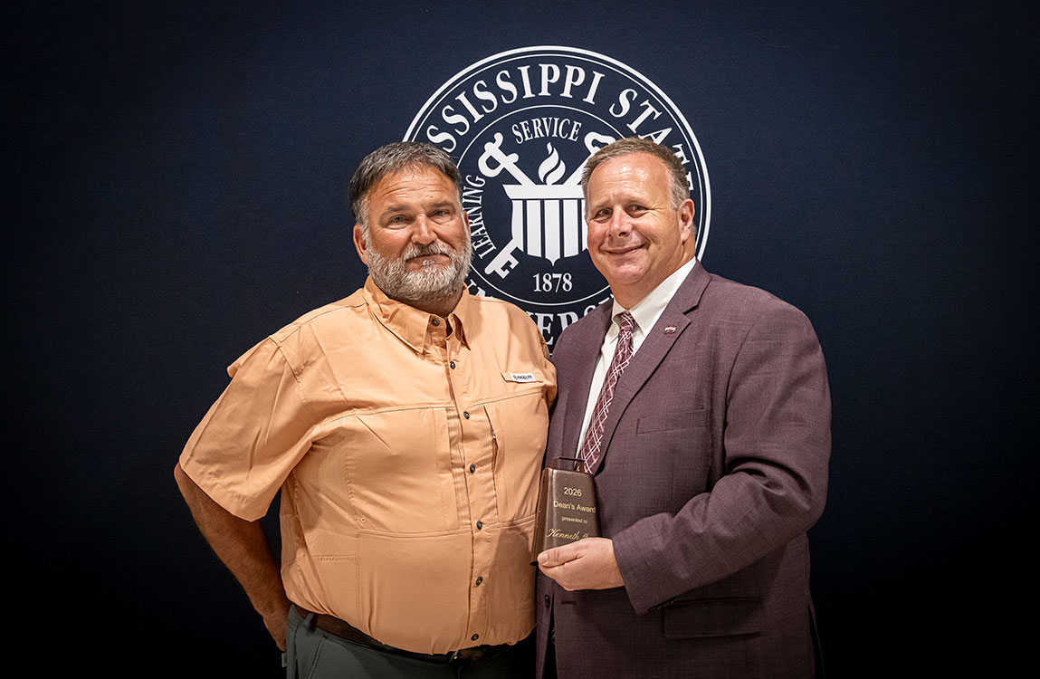 From left, Kenneth Graves, facilities manager in the Mississippi State Department of Animal and Dairy Sciences, accepts the MSU College of Agriculture and Life Sciences Dean