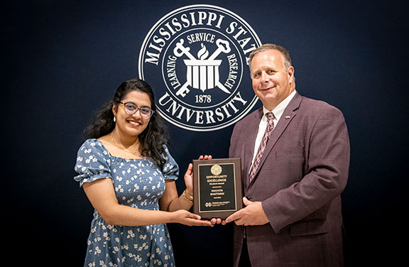 student with dean in front of black background