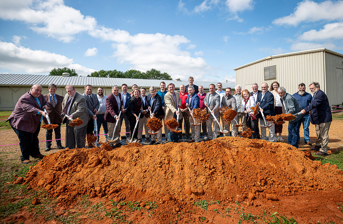 Group of people with shovels a a pile of dirt