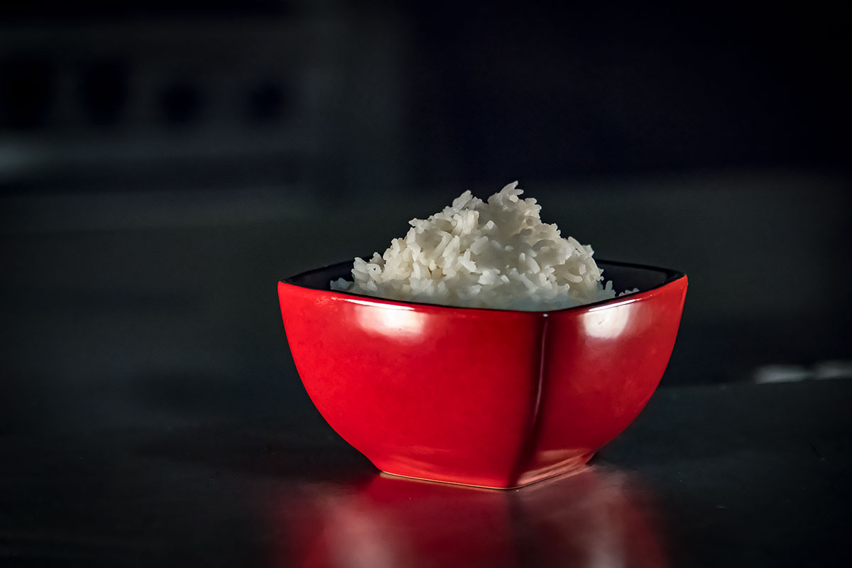 rice in a red bowl on a black background