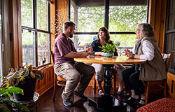 three generations sit at kitchen table