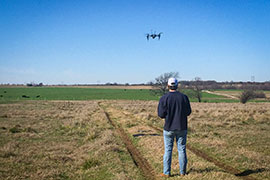 A student flies a drone over a grazing pasture to record the amount of light reflected
in key wavelengths associated with plant
health characteristics.