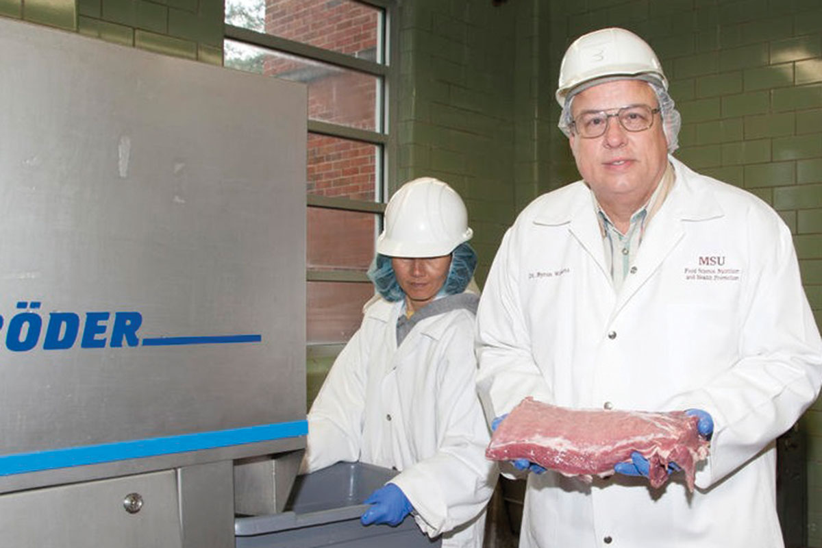 scientist with meat in a laboratory